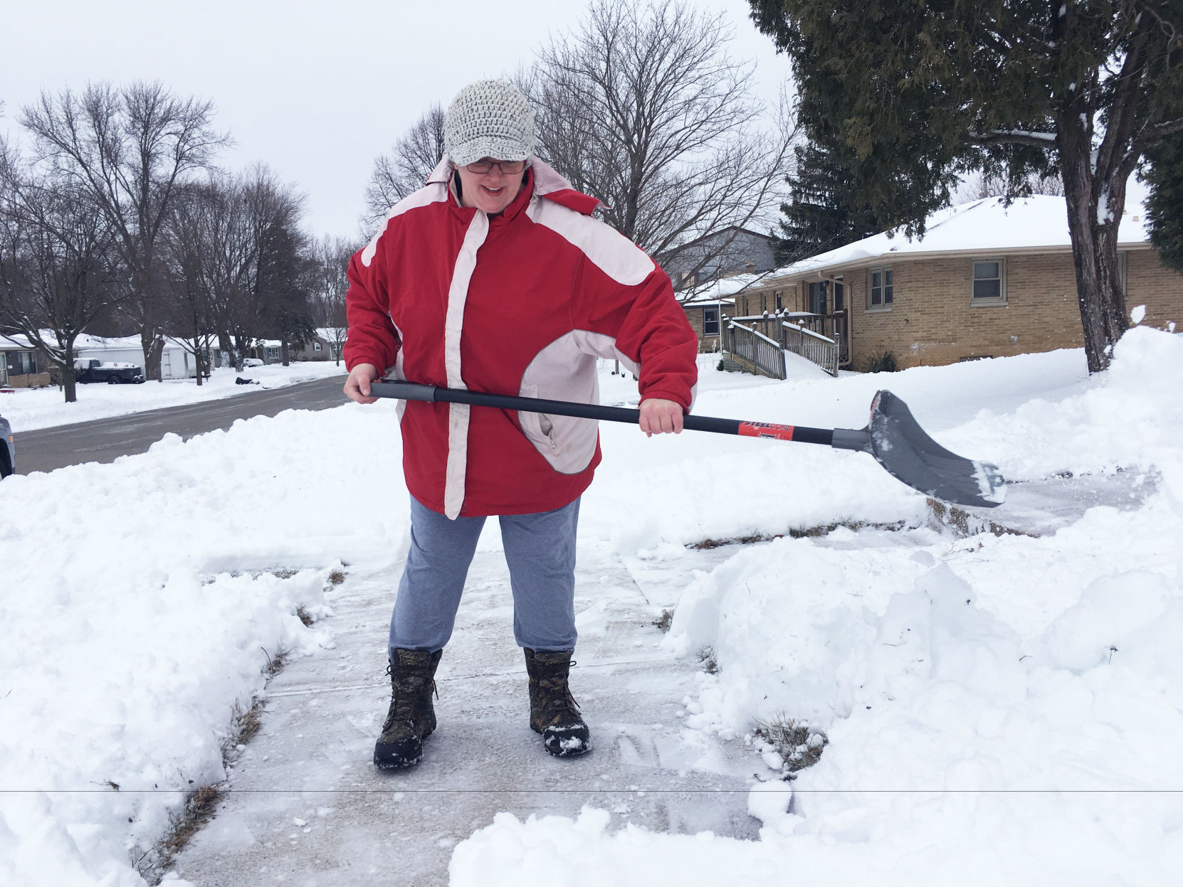 Kayla Olalde shovels snow in Burlington
